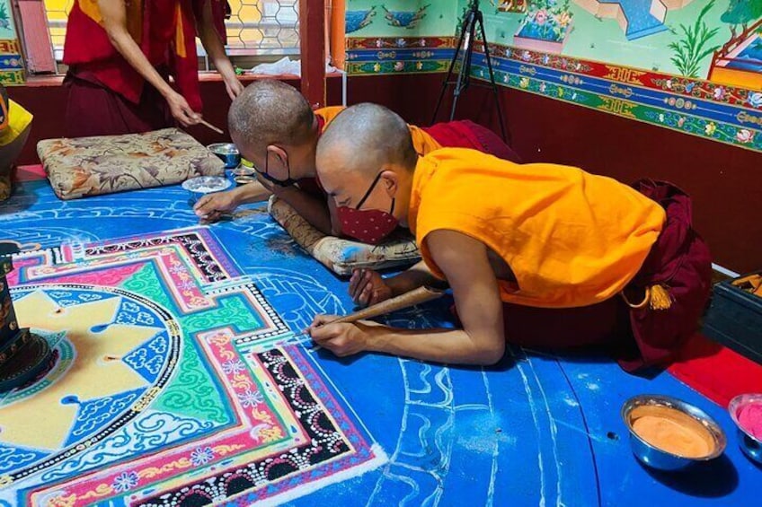 Buddhist monks making sand mandala