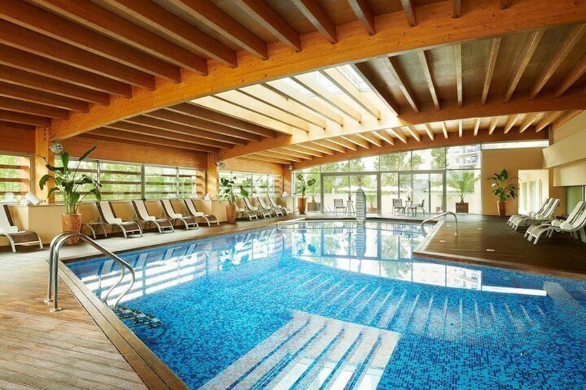 Indoor heated swimming pool with retractable roof top