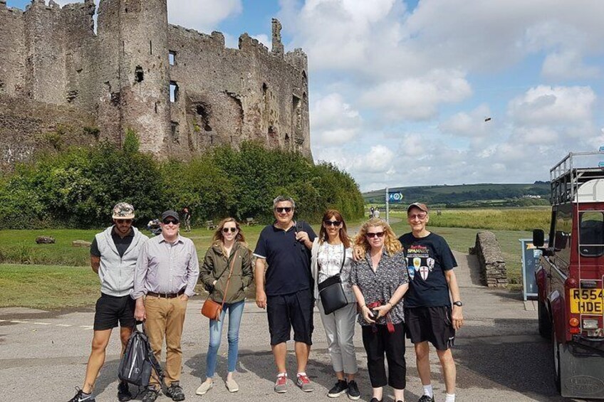 A tour arrives at Laugharne.