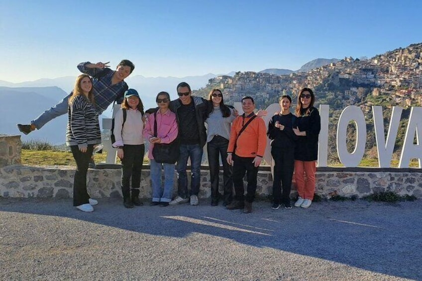 Our tour host with guests, with the town of Arachova in the background