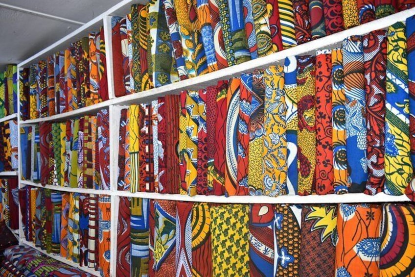 We visit a beautiful pagne market and learn the history of this colorful African/Dutch fabric!