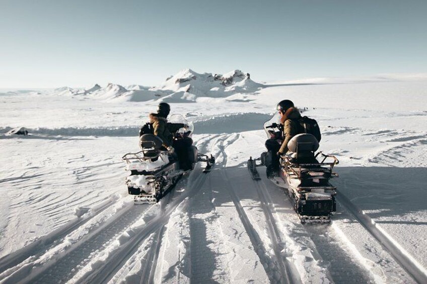 People riding on snowmobiles