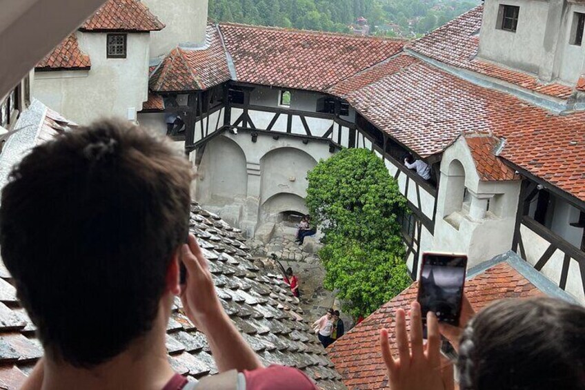 Couple picturing the Bran Castile inner courtyard.