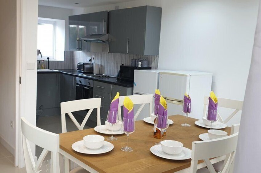 Dining room set to welcome our guests and Kitchen ready for you to cook in.