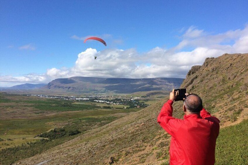 Father watches as his daughter goes paragliding.