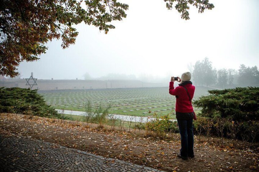 Travelers stop to take pictures of the grave sites of the Terezin Concentration Camp near Prague.