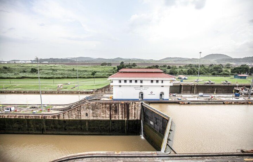 Muddy-brown water flows through the Panama Canal, the channel of water which connects the Atlantic and Pacific Oceans.