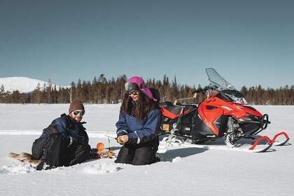 Lappish Lunch Break -Snowmobiling, ice fishing and tasty food