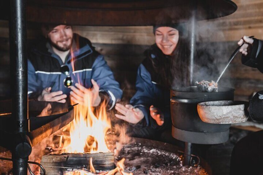 Lappish Lunch Break -Snowmobiling, ice fishing and tasty food