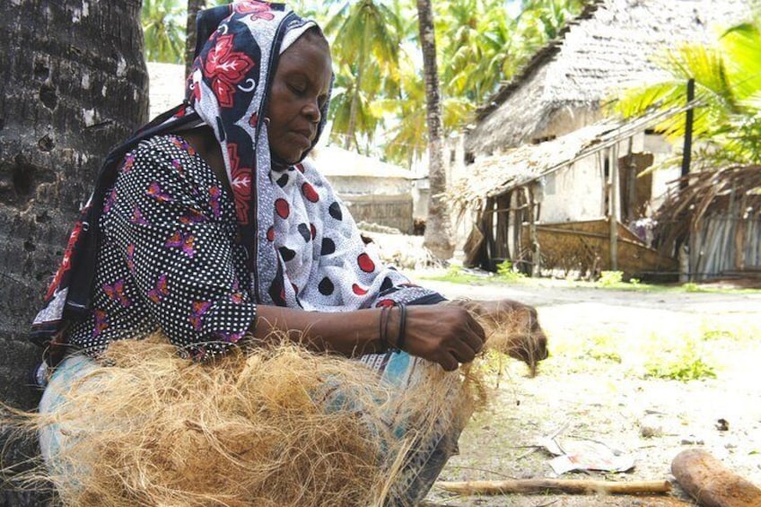 Local woman making rope from coconut fibre