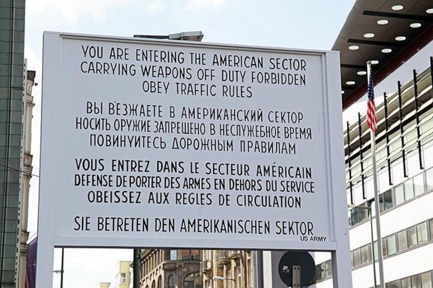 Stand at the edge of two worlds at Checkpoint Charlie