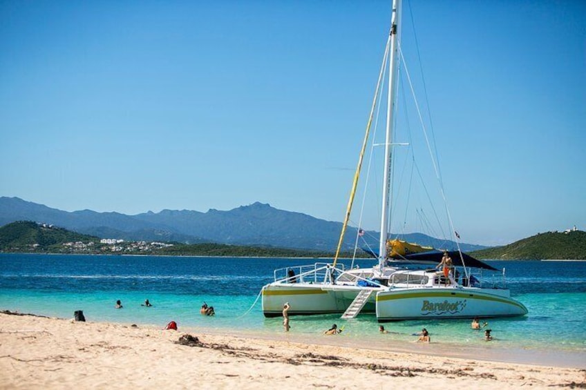 Travelers enjoy the calm waters alongside their catamaran during an island excursion from San Juan, Puerto Rico.