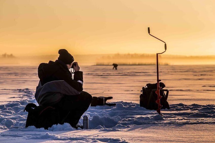 Ice fishing on a frozen lake