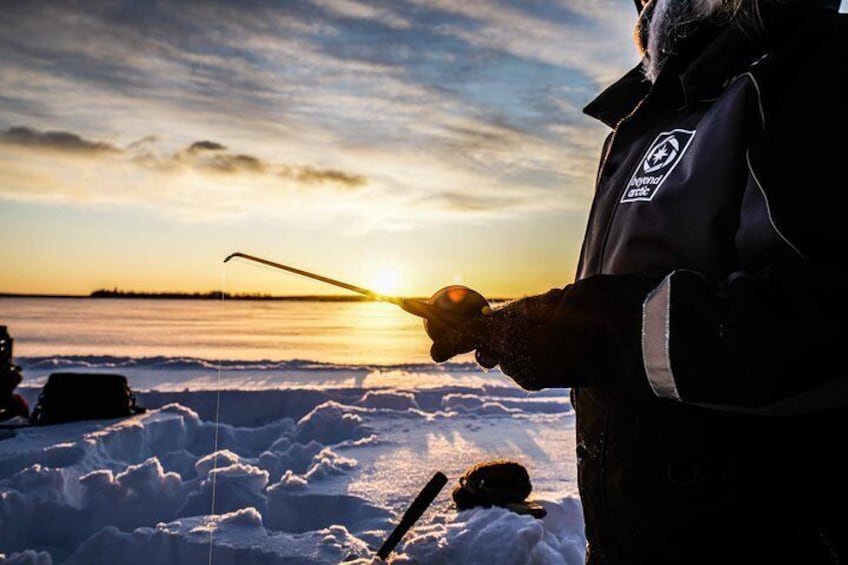 Ice fishing on a frozen lake