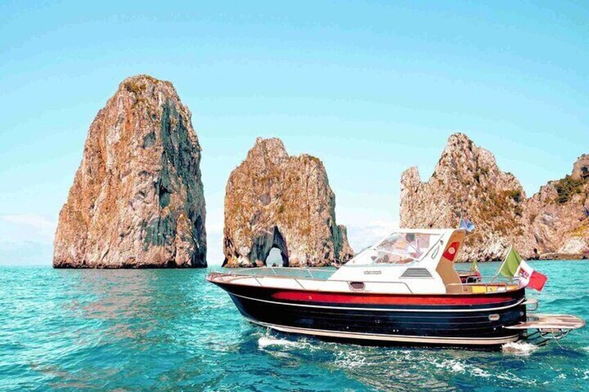 Our boats and the iconic Faraglioni rocks. 