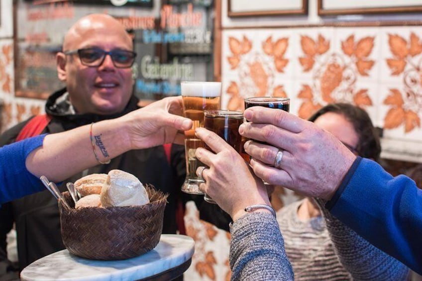 Diners toast their experience at a traditional tavern in Madrid.