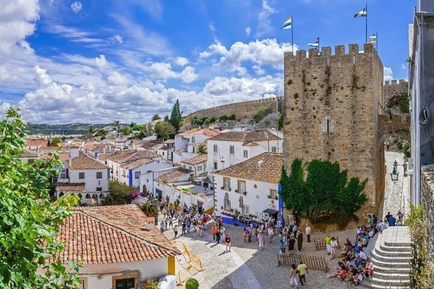 Óbidos is a medieval town with cobblestone streets and flower-bedecked, whitewashed houses