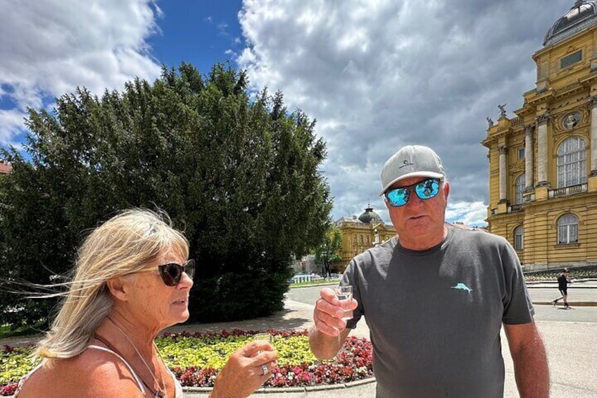 Trying local spirits in front of the opera house