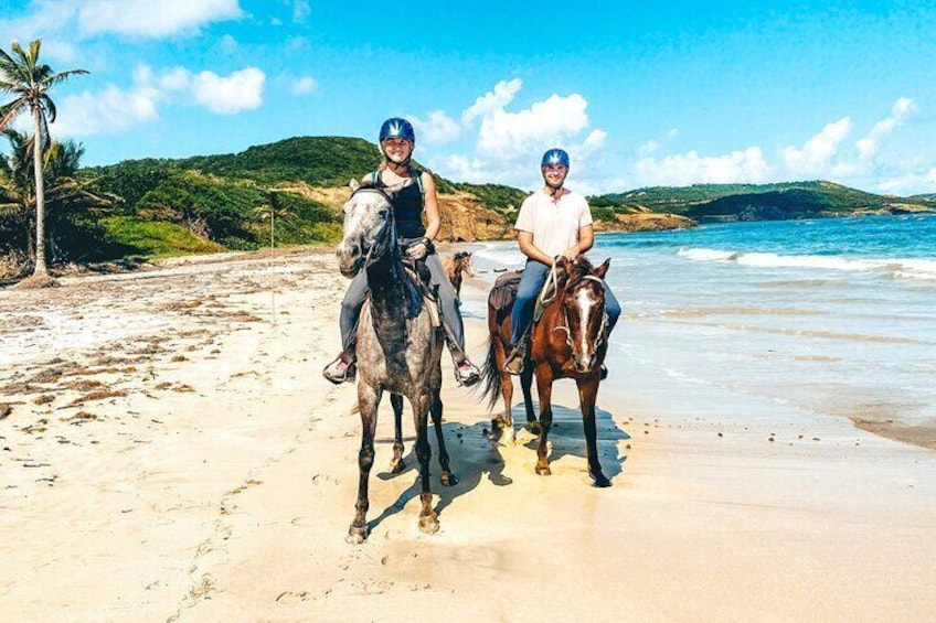 A couple riding along the beach in St. Lucia