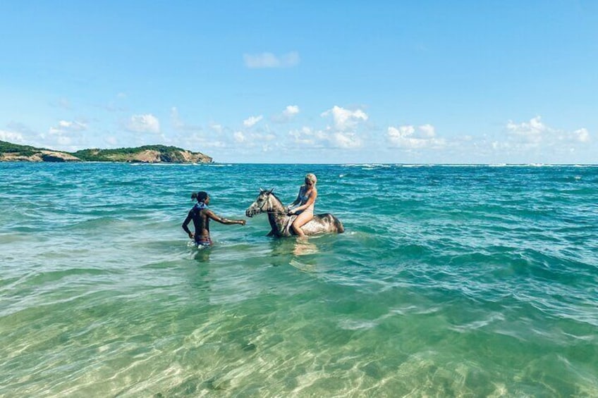 Horseback riding in the ocean.