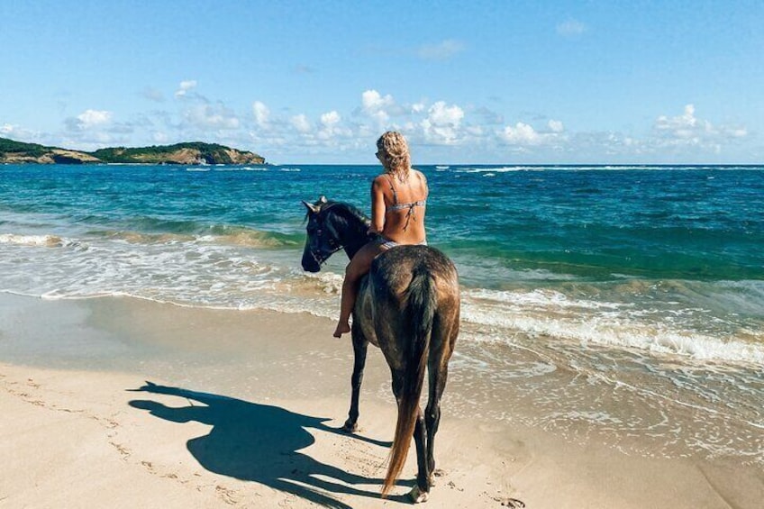 Lady riding into the ocean in St. Lucia