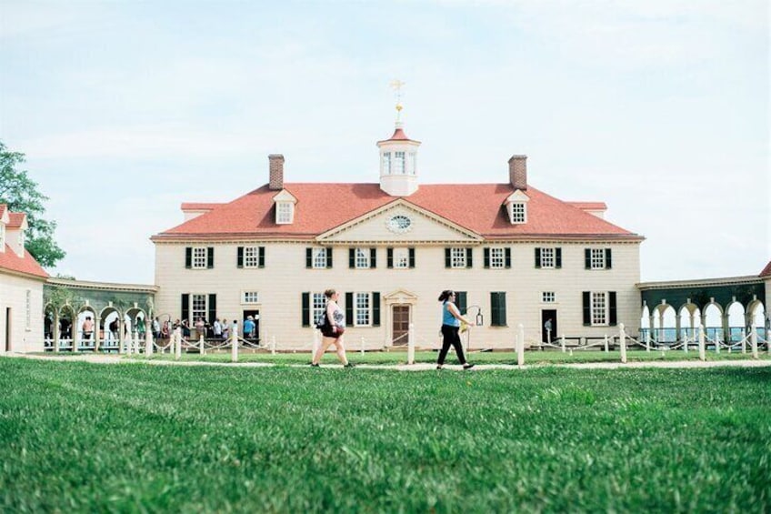 Visitors gather outside the impressive 21-room residence that anchors Mount Vernon Plantation.