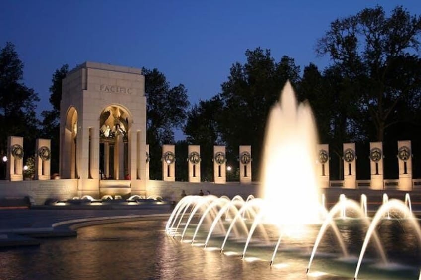 WW II Memorial lit up at night.