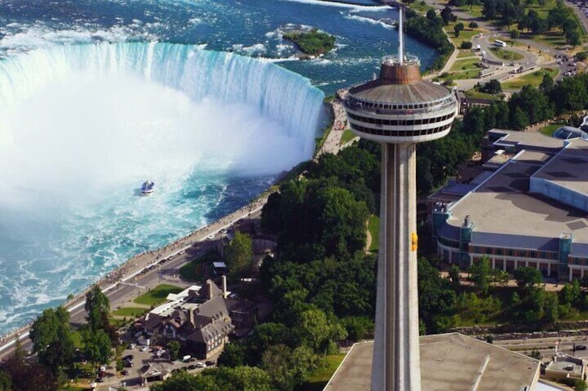 Skylon tower ride to the top of Niagara Falls Tower by yellow elevators.