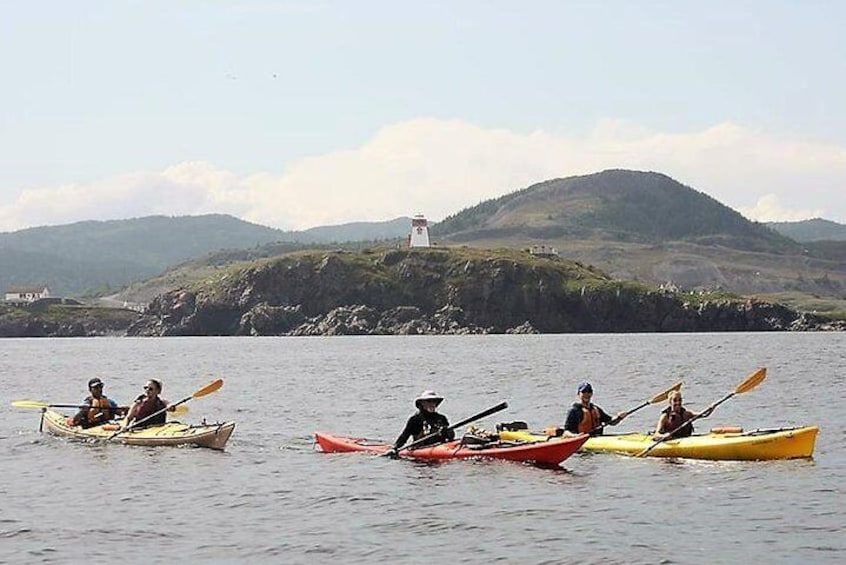 Kayak outside Trinity Harbour in front of Fort Point Lighthouse