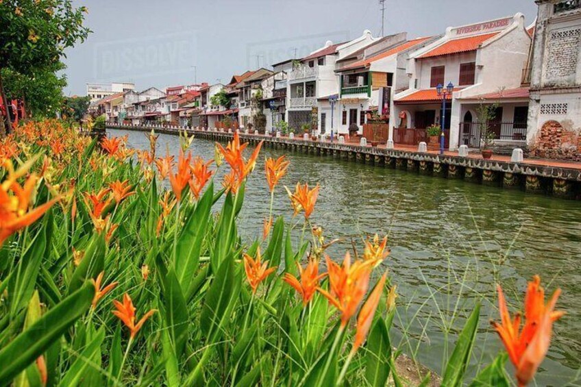 Easy stroll along the bank of the calm Malacca River