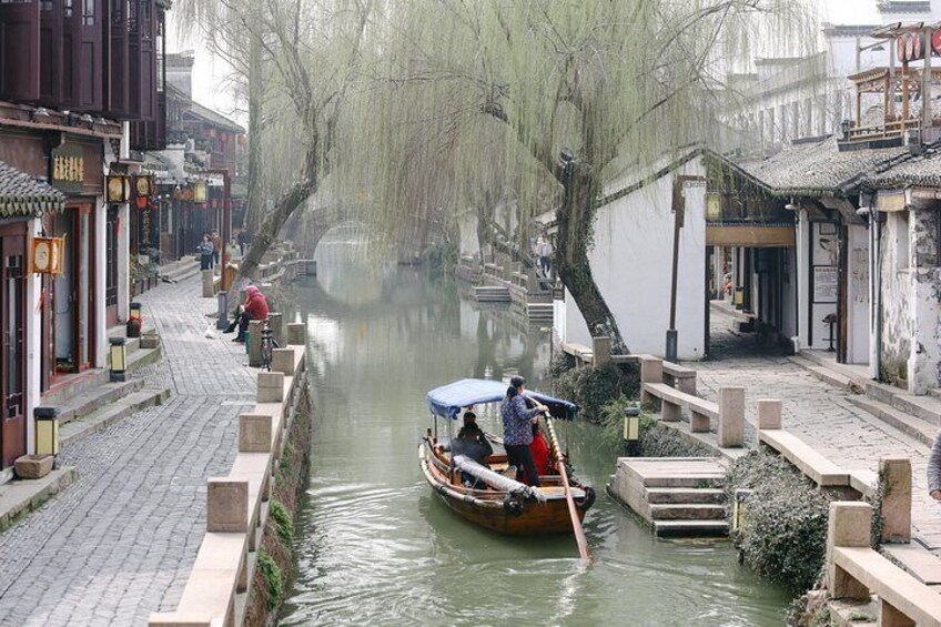 Canalboat floating through Zhouzhuang Water Village in Suzhou, China.