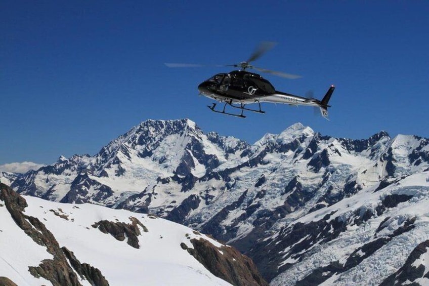 Helicopter flying over the Southern Alps