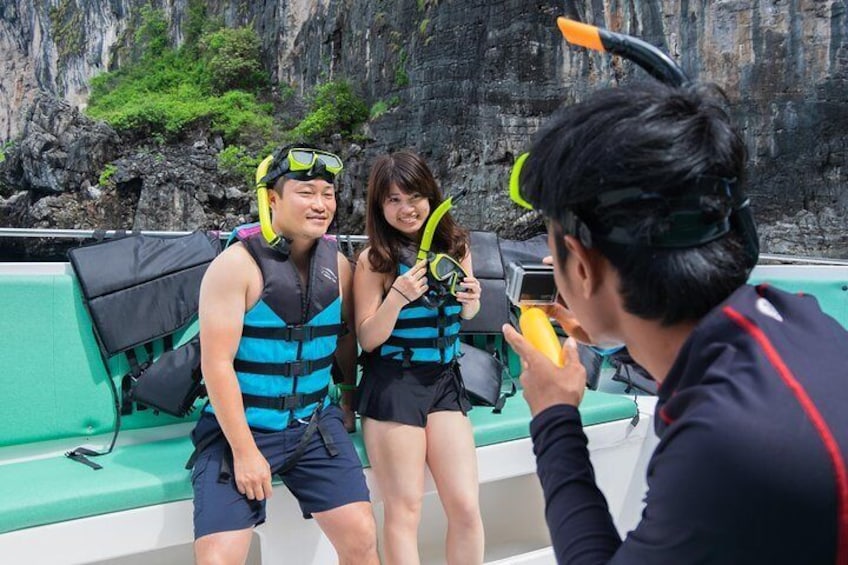 Onboard the speedboat, tourists prepare to snorkel in the waters of Phi Phi Island, Thailand.