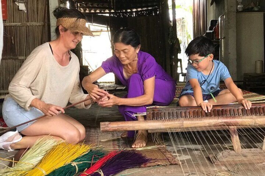 At the mat weaving family 