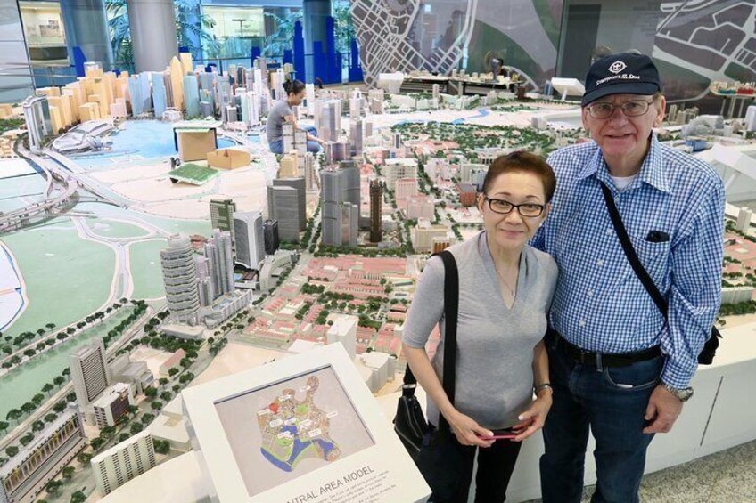 Guests taking photo with Singapore skyline miniature in the background