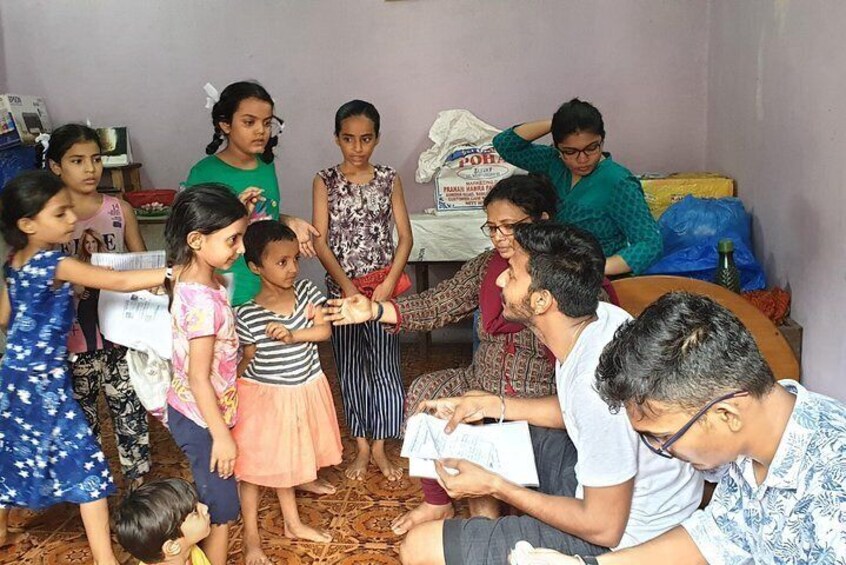 Distributing free notebooks in slum 