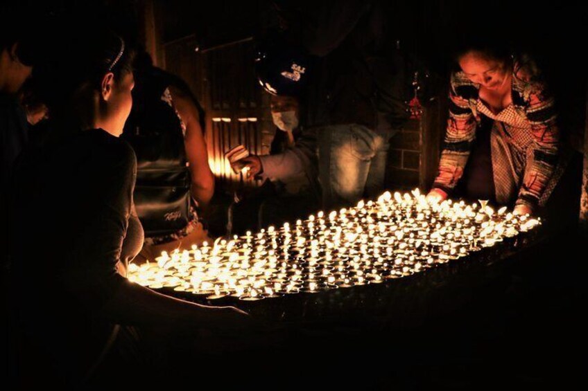 Lighting butter lamp in memory of loved ones who has past away