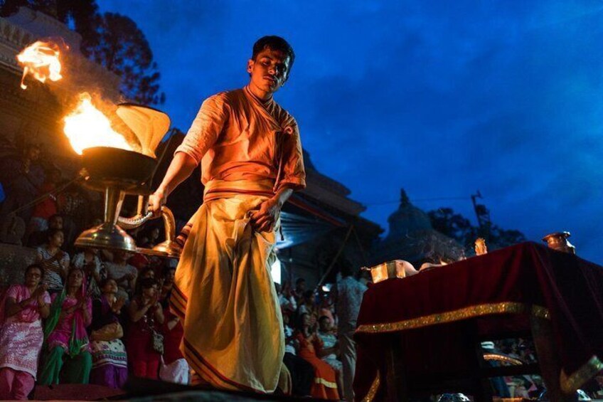Divine Rituals: Photograph the priests performing the Aarati with the flickering lights reflecting on the river, symbolizing the worship of Lord Shiva.