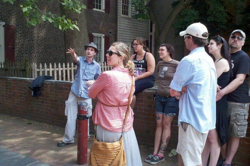 Grim Philly guide with a group of tourists in historic Philadelphia