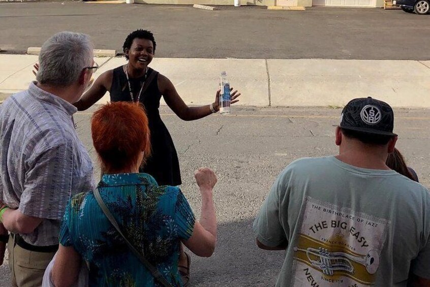 Miss Mary shares a story about John Goodman in front of his home, 