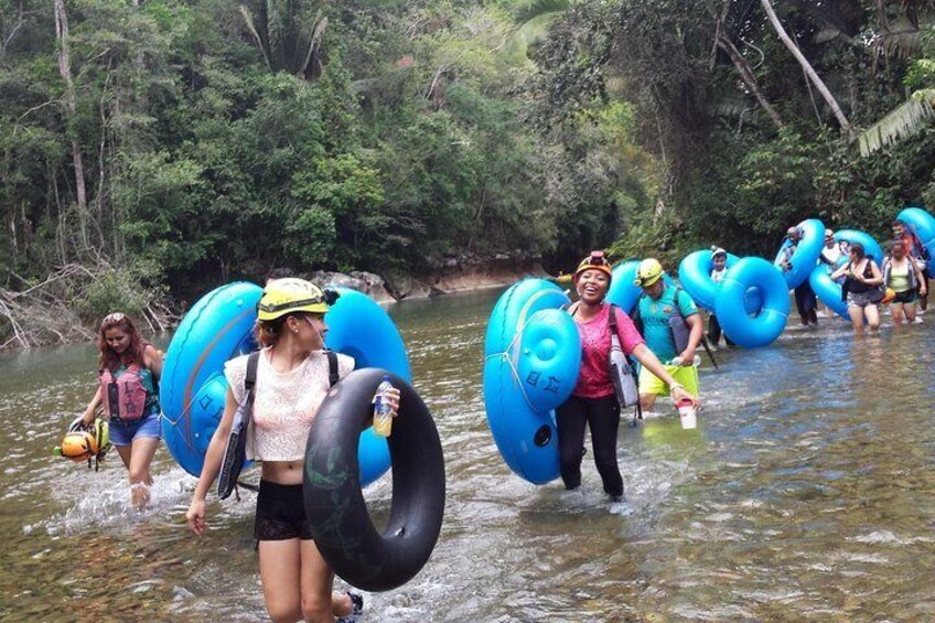 The hike and river crossing with tubes during the cave tubing tour. 