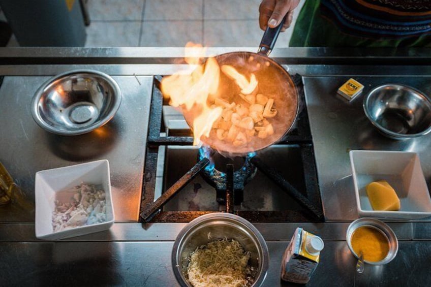 Peruvian chef demonstrates how to sauté mushrooms as part of a traditional dish which is going to be served to his guests.