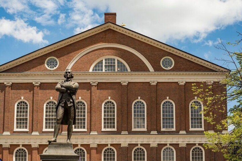 Walk in the shadow of the Samuel Adams Statue at iconic Faneuil Hall (1742)