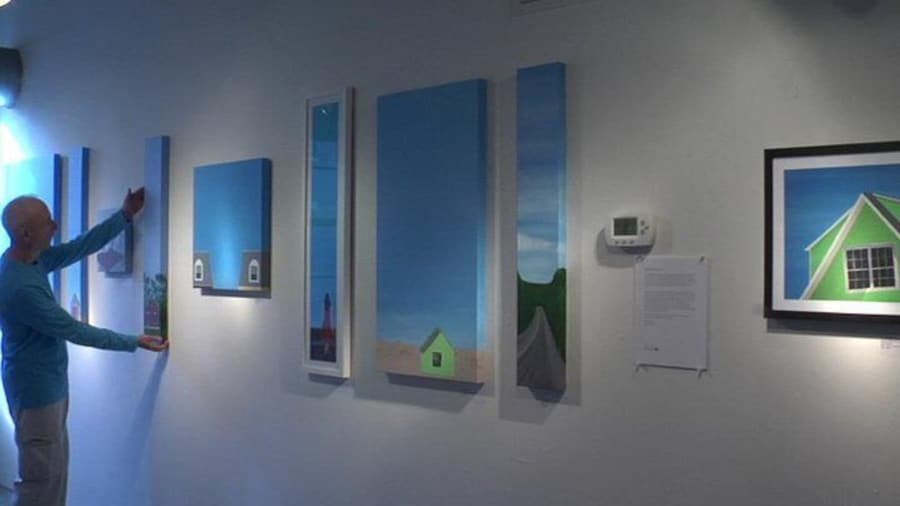 The artist curates a studio wall.