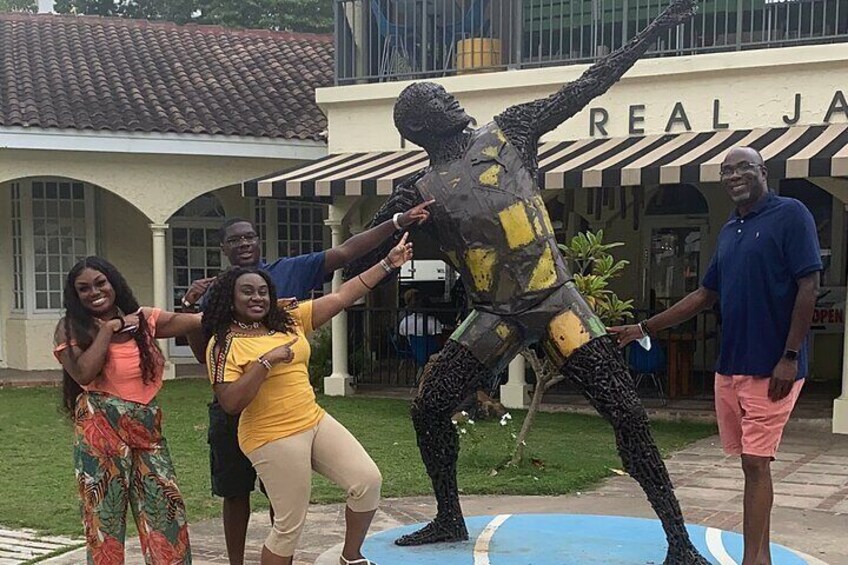 Posing with the Usain bolt statue