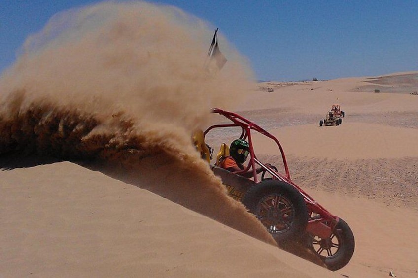 Drop over dunes and kick up some sand!