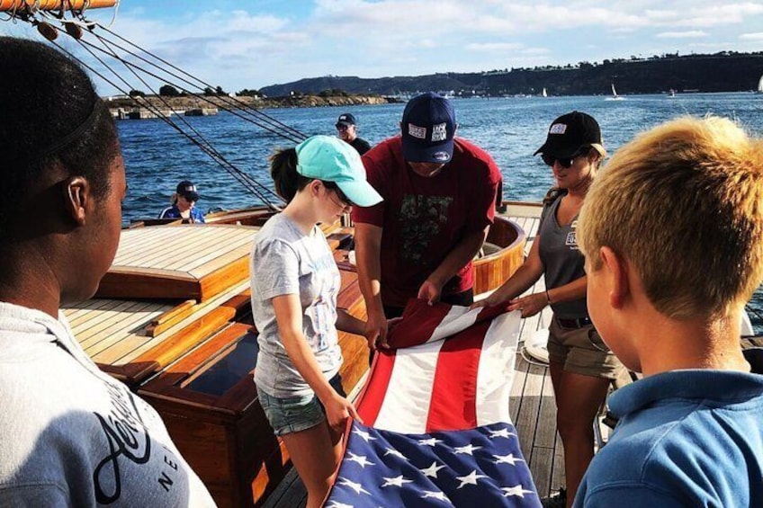 Kids folding the American Flag 