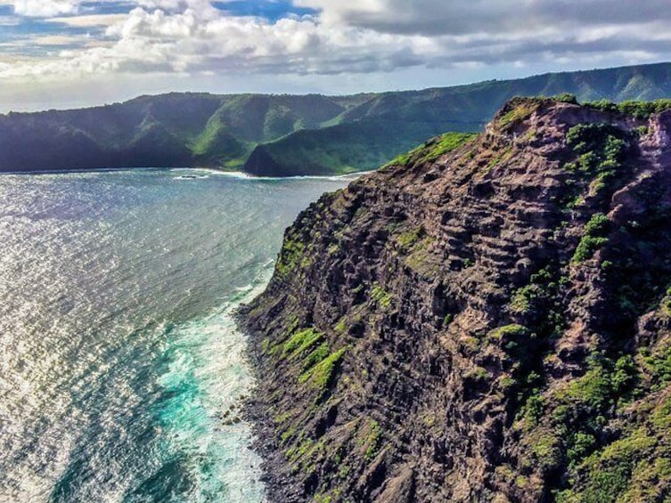 Layers of volcanic rock are clearly visible on this exposed cliff face along Maui's west coast.