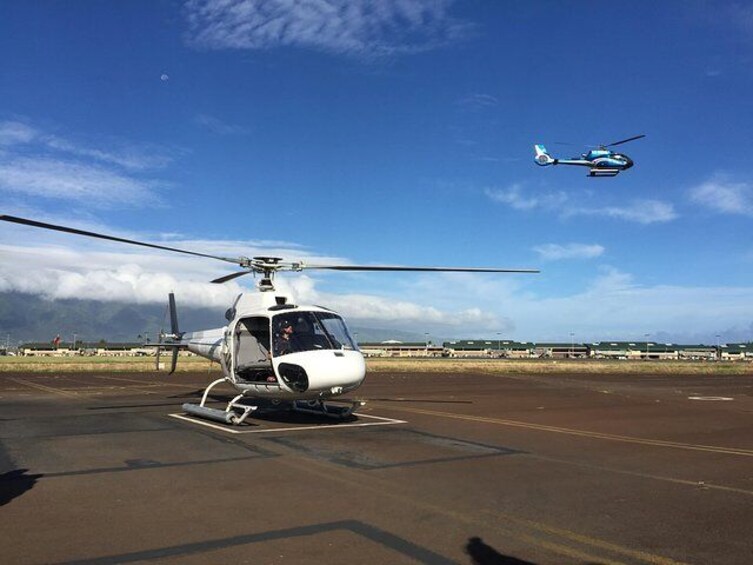 Depart from Kahului heliport aboard a doors-off helicopter.