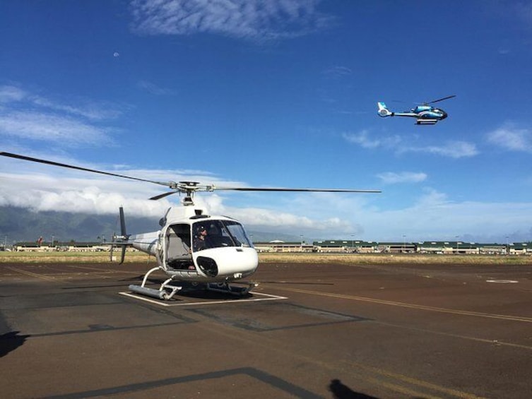 Depart from Kahului heliport aboard a doors-off helicopter.
